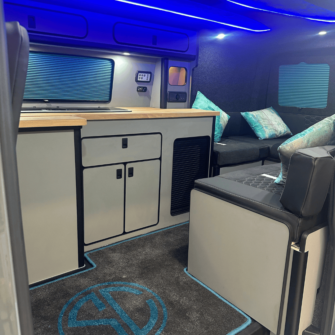 Mobile office van interior with workspace, seating, and modern amenities for remote working.